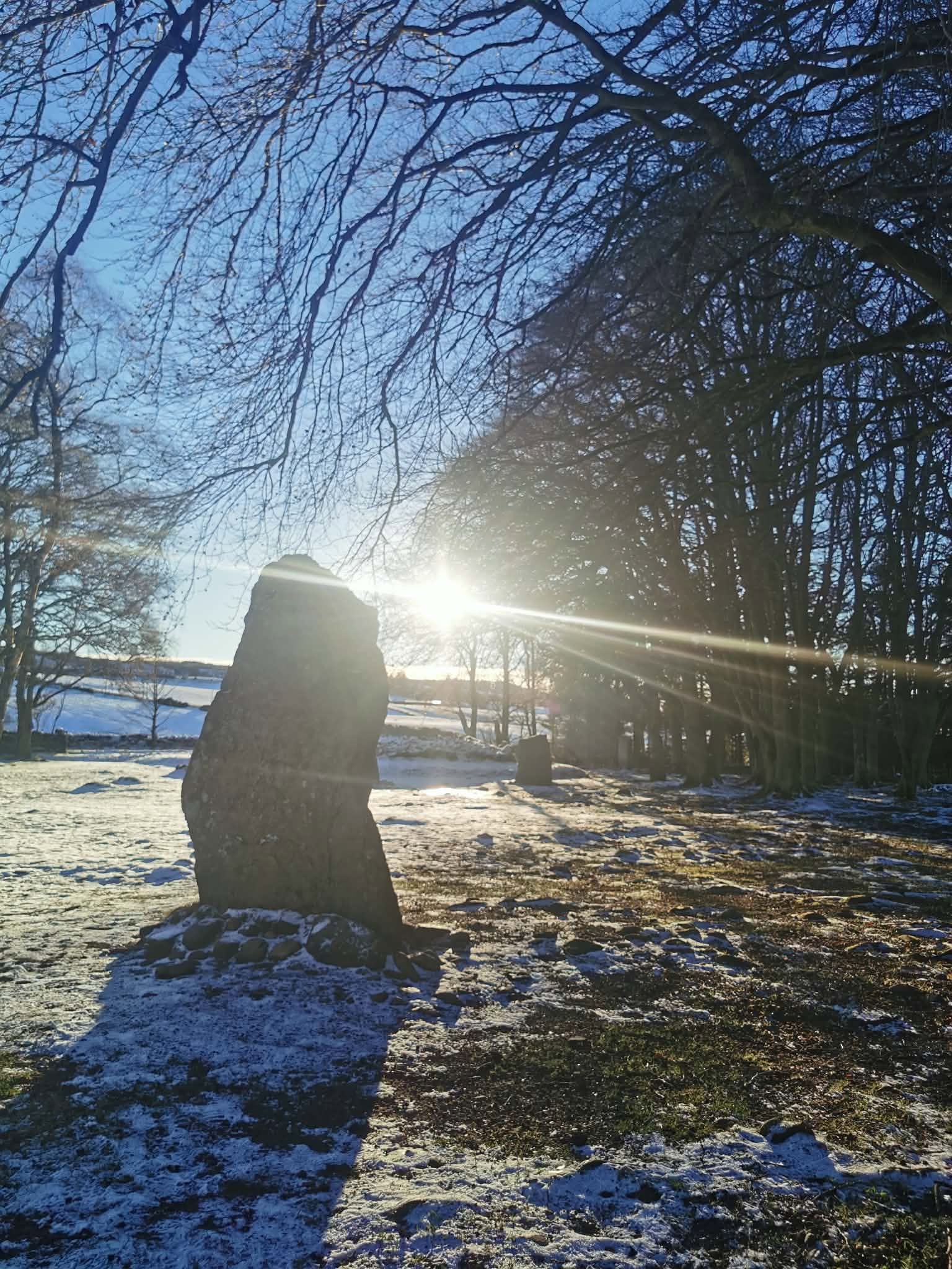 A Clava Cairns stone lit by sunlight