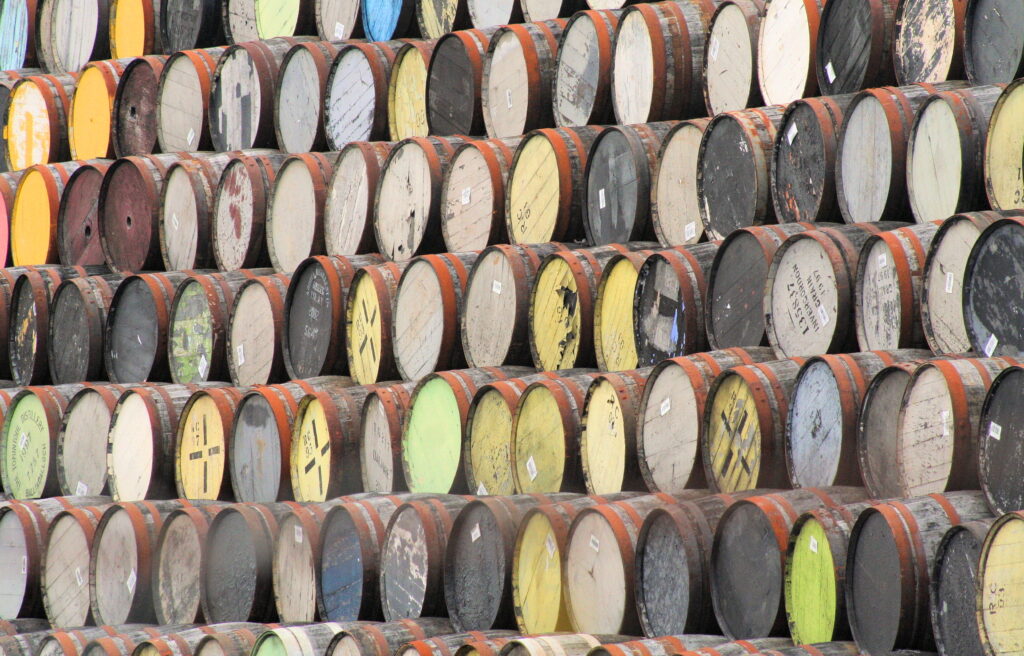 Rows of traditional whisky barrels in a Scottish warehouse